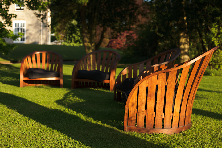 wooden seating by lake and gardens